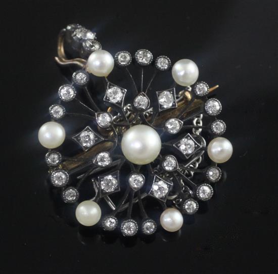 An early 20th century gold and silver, diamond and cultured pearl set openwork circular pendant brooch, 1.25in.
